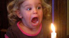 Малышка очень смешно пытается задуть свечу